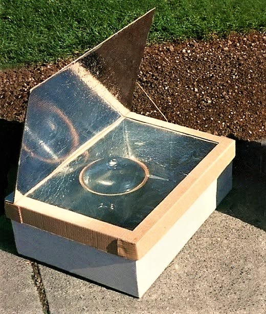 A solar pasteurisation device in the shape of a box with a glass cover and a reflecting interior and folding lid. The water container is put inside the box and heated with solar heat. Source: CAWST (2009)