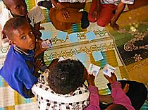 Children playing cards within the CHAST approach. Source: IRC (2006)