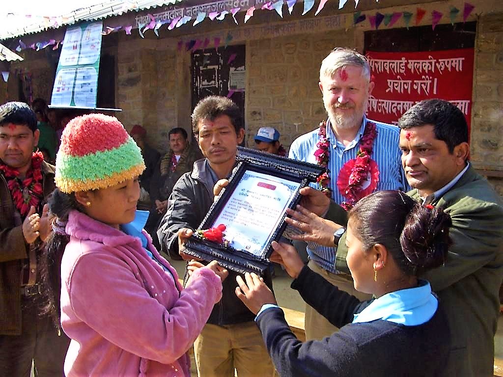Community members from a small village in Nepal receive an award for achieving the “open defecation free status” after a successful CLTS Campaign. Source: KROPAC (2009)